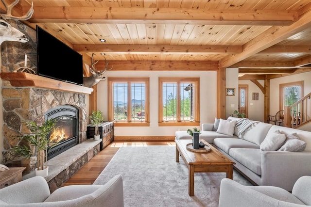 51193 Smith Creek Park Rd, Steamboat Springs, CO 80487 - living room with wood finished floors, wood ceiling, beamed ceiling, healthy amount of natural light, and a stone fireplace