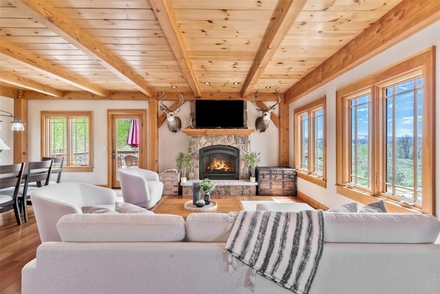 51193 Smith Creek Park Rd, Steamboat Springs, CO 80487 - living area with a fireplace, beam ceiling, wood finished floors, wood ceiling, and baseboards