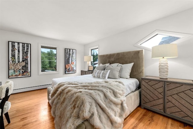 203 Spruce St, Steamboat Springs, CO 80487 - bedroom featuring light wood finished floors and baseboard heating
