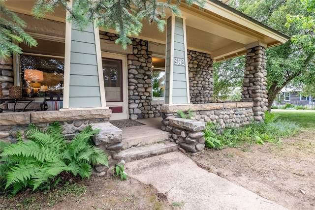 203 Spruce St, Steamboat Springs, CO 80487 - property entrance featuring covered porch and stone siding