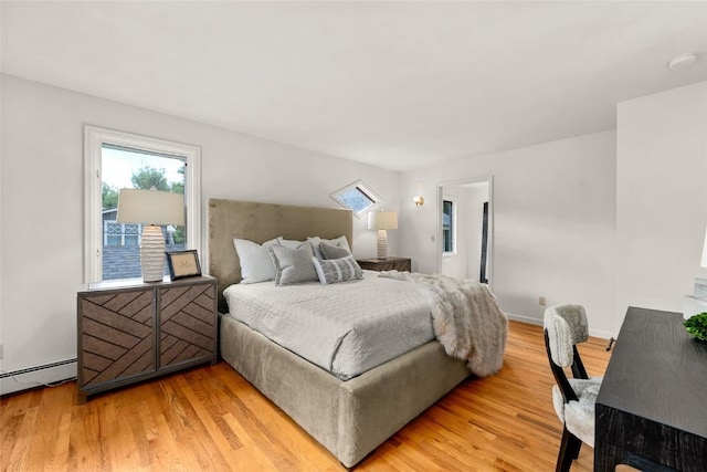203 Spruce St, Steamboat Springs, CO 80487 - bedroom featuring light wood-style floors and a baseboard heating unit