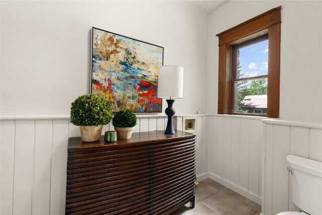 203 Spruce St, Steamboat Springs, CO 80487 - bathroom featuring a decorative wall, wainscoting, and toilet