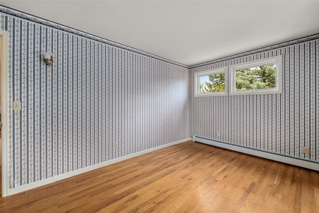 203 Spruce St, Steamboat Springs, CO 80487 - spare room with light wood-type flooring, baseboard heating, wallpapered walls, and baseboards