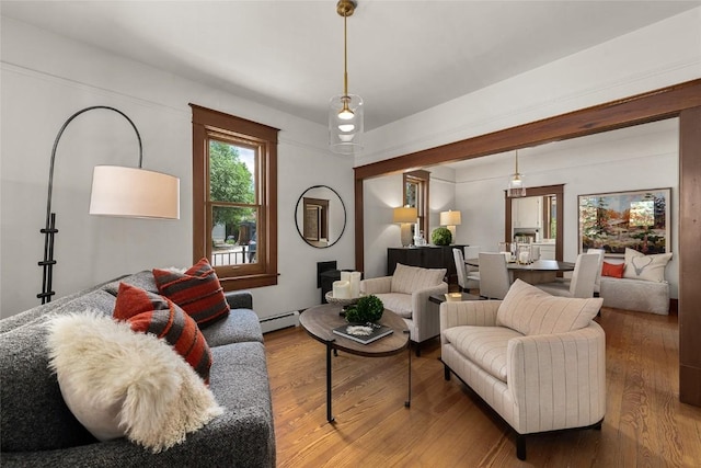 203 Spruce St, Steamboat Springs, CO 80487 - living area featuring a baseboard heating unit and wood finished floors