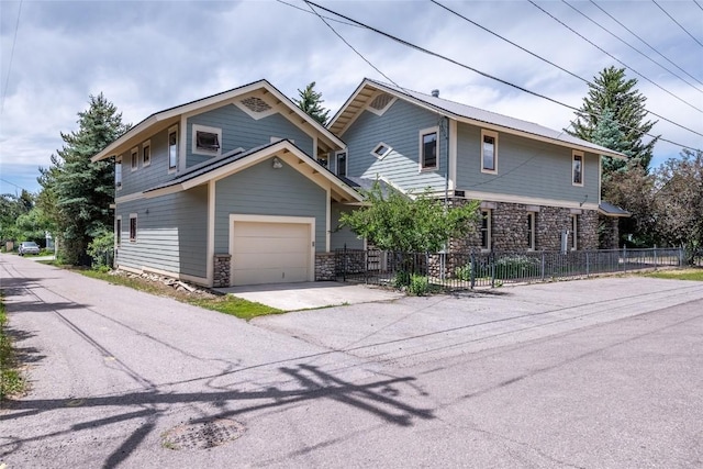 203 Spruce St, Steamboat Springs, CO 80487 - view of front of property with stone siding, fence, and driveway
