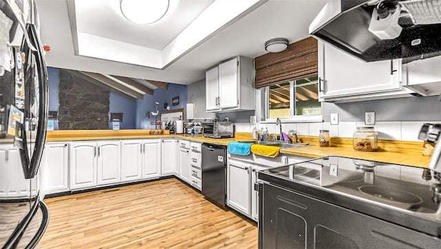 1226 Barclay St, Craig, CO 81625 - kitchen featuring dishwashing machine, electric range, extractor fan, light wood-style floors, and wood counters