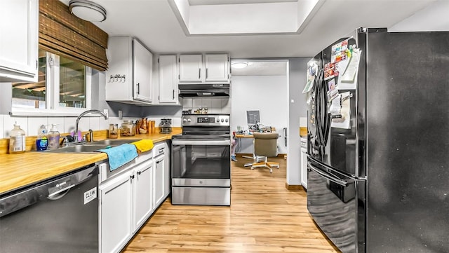 1226 Barclay St, Craig, CO 81625 - kitchen featuring freestanding refrigerator, dishwashing machine, stainless steel range with electric cooktop, ventilation hood, and light wood-type flooring