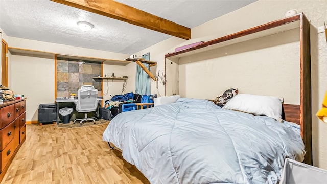 1226 Barclay St, Craig, CO 81625 - bedroom featuring light wood-style floors, beam ceiling, and a textured ceiling