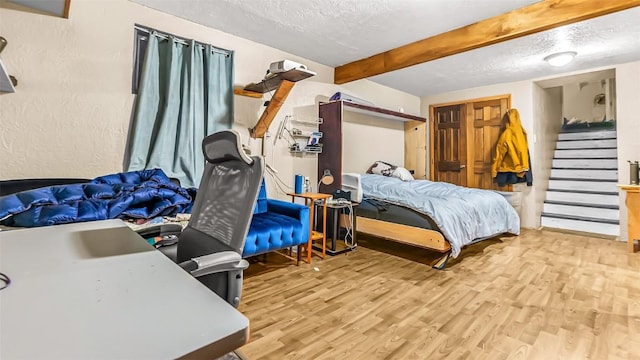1226 Barclay St, Craig, CO 81625 - bedroom featuring beam ceiling, wood finished floors, and a textured ceiling