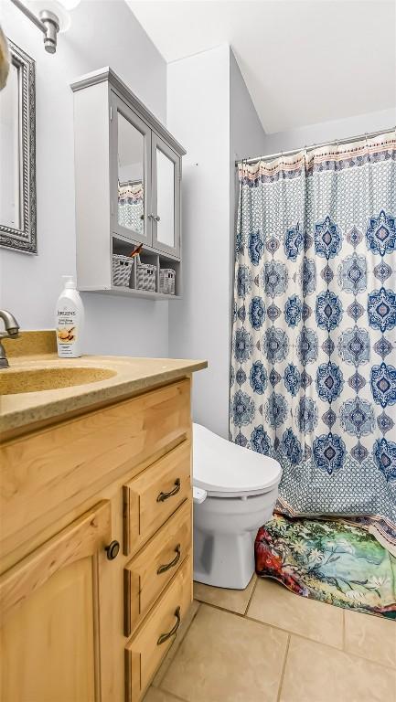 1226 Barclay St, Craig, CO 81625 - bathroom with vanity, tile patterned floors, and curtained shower