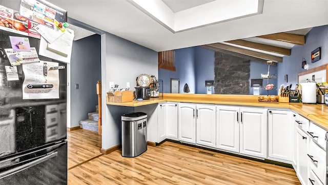 1226 Barclay St, Craig, CO 81625 - kitchen with light wood-type flooring, white cabinets, butcher block countertops, and freestanding refrigerator