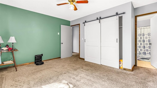 1226 Barclay St, Craig, CO 81625 - unfurnished bedroom with carpet, a barn door, a ceiling fan, and ensuite bathroom