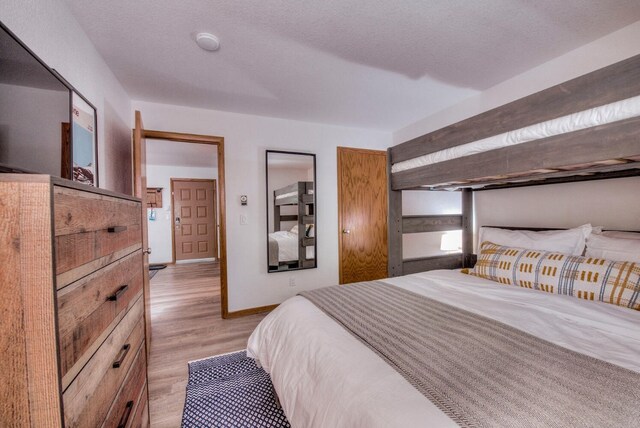 23034 US Highway 6 Unit 305, Keystone, CO 80435 - bedroom featuring light wood-type flooring and baseboards