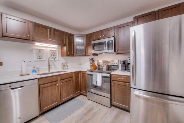 23034 US Highway 6 Unit 305, Keystone, CO 80435 - kitchen with light countertops, light wood-type flooring, stainless steel appliances, and a sink