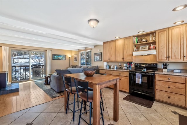 2930 Columbine Dr Unit 102, Steamboat Springs, CO 80487 - kitchen with electric range, light tile patterned floors, under cabinet range hood, open floor plan, and beam ceiling