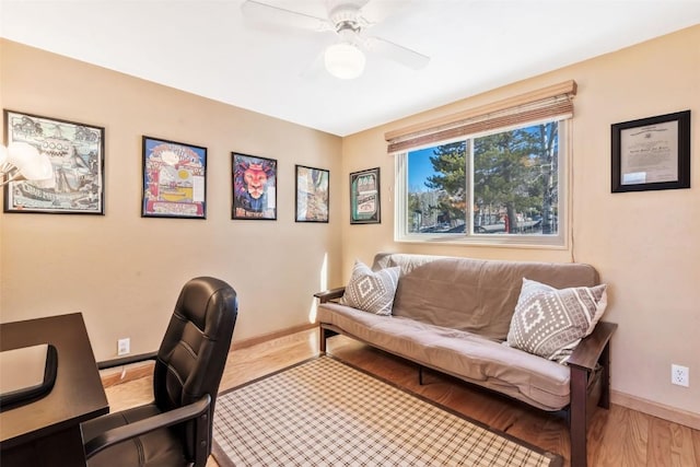 office with wood finished floors, a ceiling fan, and baseboards
