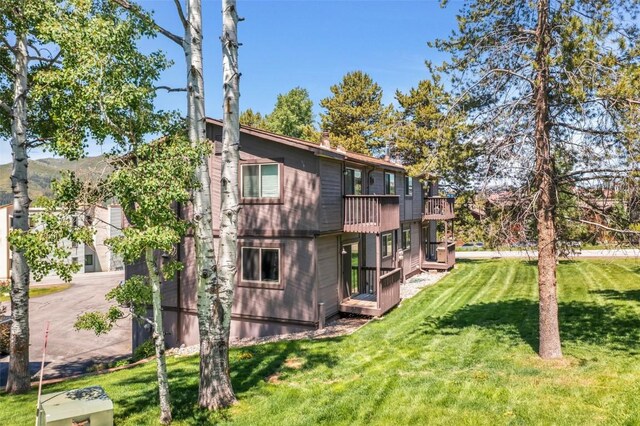2930 Columbine Dr Unit 102, Steamboat Springs, CO 80487 - rear view of house featuring a lawn and a deck