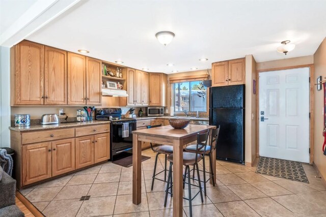 kitchen with light tile patterned floors, open shelves, under cabinet range hood, and black appliances