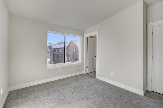 interior space with baseboards and carpet