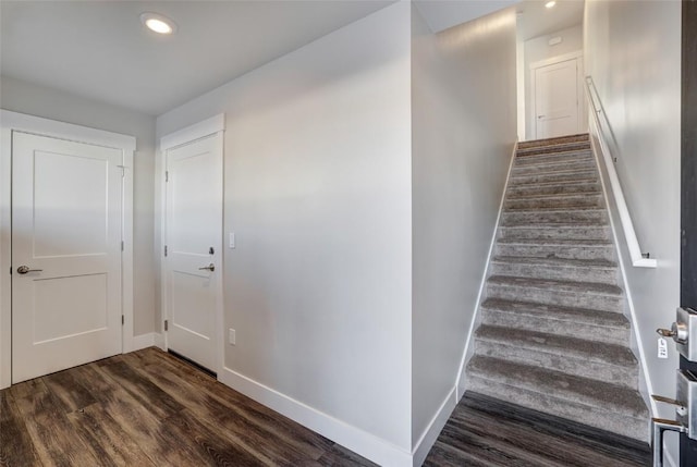 stairway with recessed lighting, wood finished floors, and baseboards