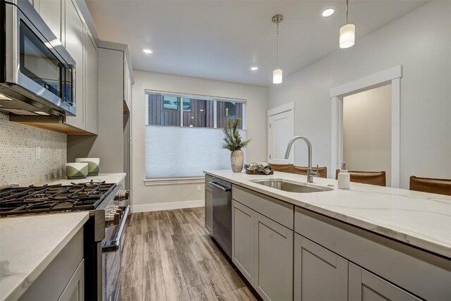 1301 Adams Ave Unit 122, Silverthorne, CO 80498 - kitchen with stainless steel appliances, a sink, gray cabinetry, backsplash, and recessed lighting