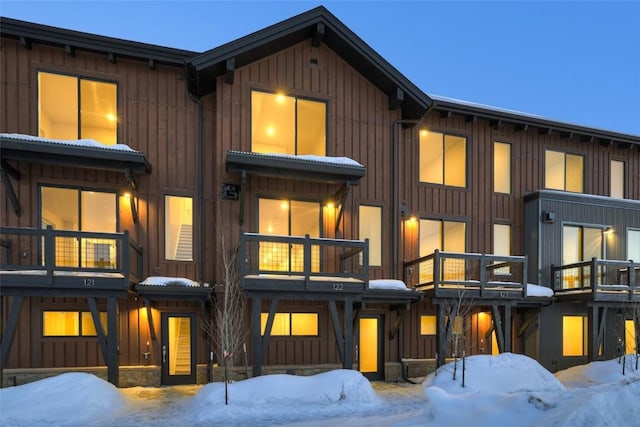 view of front of house featuring board and batten siding and a balcony