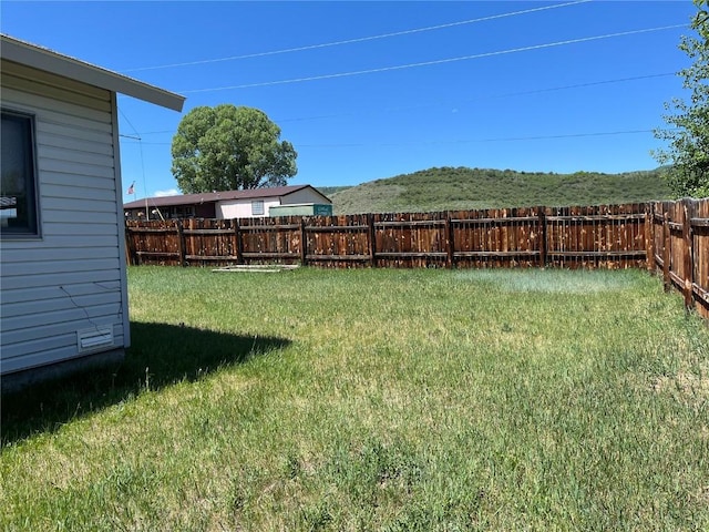 21725 4th Ave, Phippsburg, CO 80469 - fenced backyard featuring a mountain view