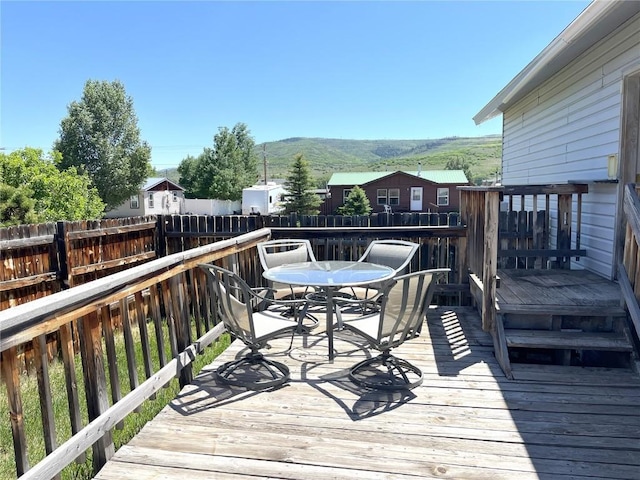21725 4th Ave, Phippsburg, CO 80469 - wooden deck featuring outdoor dining space and a mountain view