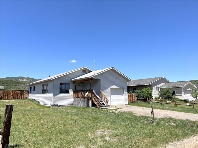 21725 4th Ave, Phippsburg, CO 80469 - view of front of house with a garage and dirt driveway