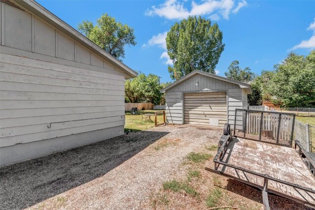 view of yard with a garage and an outdoor structure