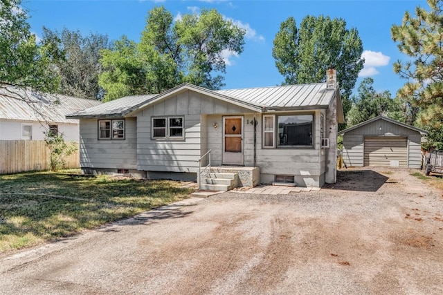 ranch-style home with an outbuilding, a front lawn, and a garage