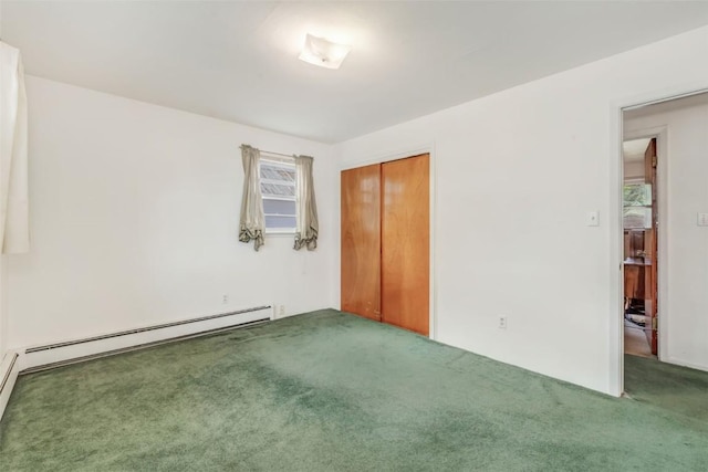 carpeted spare room with a baseboard radiator