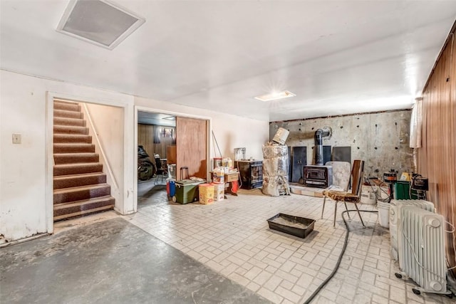 interior space with a wood stove and wooden walls