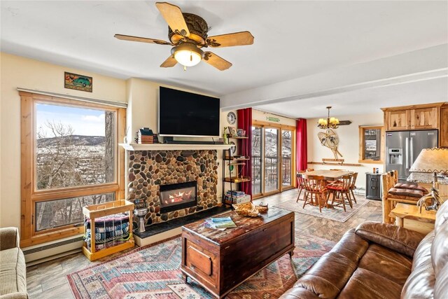 dining space featuring plenty of natural light, an inviting chandelier, a baseboard radiator, and a mountain view