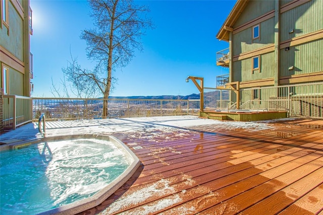 wooden terrace with a mountain view and hot tub deck surround
