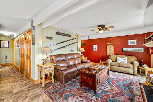 2626 Longthong Rd Unit 104, Steamboat Springs, CO 80487 - living area featuring ceiling fan, wood finished floors, beamed ceiling, and baseboards