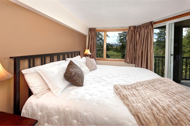 21640 US Highway 6 Unit 2122, Keystone, CO 80435 - bedroom featuring access to exterior, a textured ceiling, and vaulted ceiling