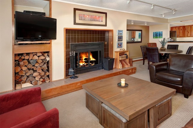 21640 US Highway 6 Unit 2122, Keystone, CO 80435 - living room with light colored carpet, a tile fireplace, a textured ceiling, and track lighting
