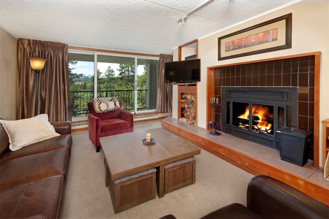 21640 US Highway 6 Unit 2122, Keystone, CO 80435 - living area with a tile fireplace, carpet flooring, rail lighting, and a textured ceiling