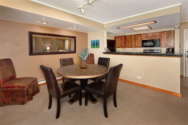 21640 US Highway 6 Unit 2122, Keystone, CO 80435 - dining area with light colored carpet, a textured ceiling, track lighting, and a baseboard radiator