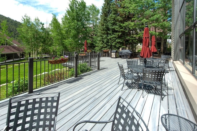 21640 US Highway 6 Unit 2122, Keystone, CO 80435 - wooden terrace featuring outdoor dining area, a yard, and a grill