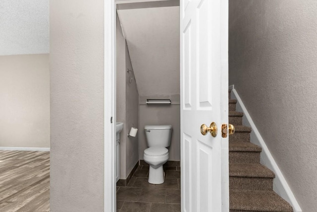 20 Sequoia Ct Unit 20, Steamboat Springs, CO 80487 - bathroom featuring a textured wall, toilet, baseboards, and tile patterned flooring