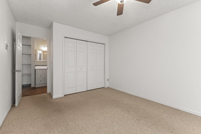 20 Sequoia Ct Unit 20, Steamboat Springs, CO 80487 - unfurnished bedroom featuring carpet flooring, baseboards, a closet, ceiling fan, and connected bathroom
