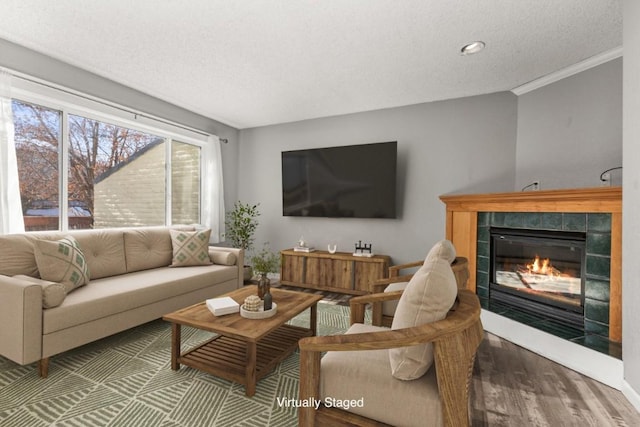 20 Sequoia Ct Unit 20, Steamboat Springs, CO 80487 - living room with wood finished floors, a textured ceiling, a fireplace, and ornamental molding