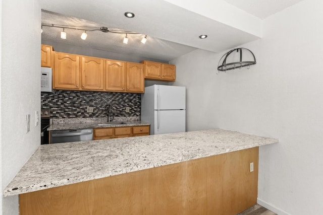 20 Sequoia Ct Unit 20, Steamboat Springs, CO 80487 - kitchen with white appliances, a sink, light stone counters, and tasteful backsplash