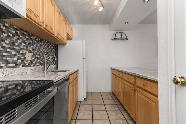 20 Sequoia Ct Unit 20, Steamboat Springs, CO 80487 - kitchen featuring stainless steel dishwasher, a sink, tasteful backsplash, a textured ceiling, and light stone counters
