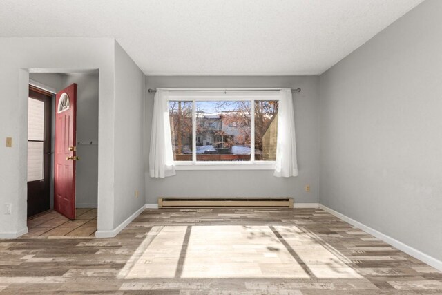 20 Sequoia Ct Unit 20, Steamboat Springs, CO 80487 - empty room featuring wood finished floors, baseboard heating, and baseboards