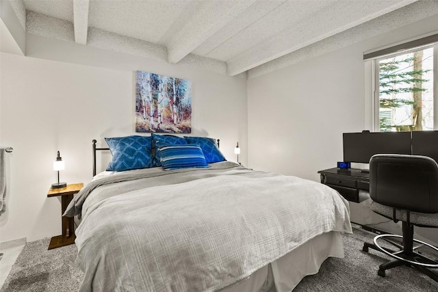 carpeted bedroom with beam ceiling and a textured ceiling
