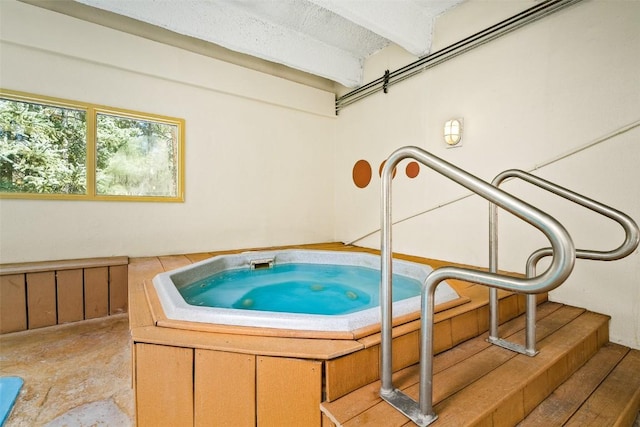 view of swimming pool with an indoor hot tub