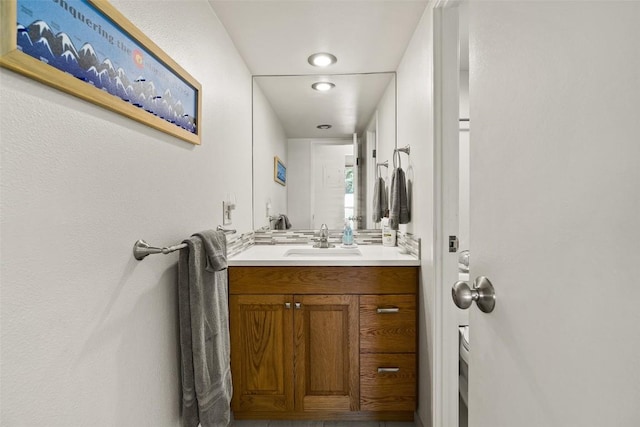 bathroom with vanity, recessed lighting, and toilet